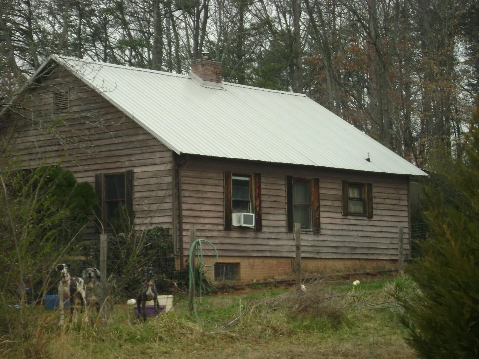 White metal roof on an old wood sided farmhouse, from a Metal Roof Installation job in Rineyville
